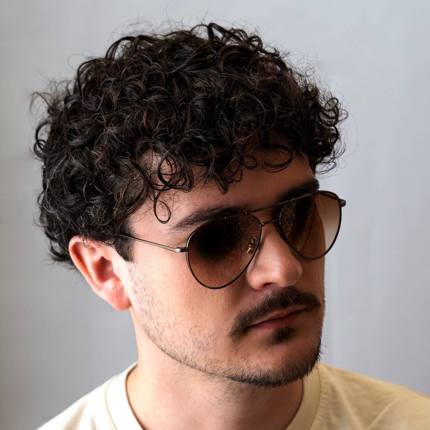 "LES" Aviator, portées par un model masculin. Le monogramme apparait légèrement dans la lumière.